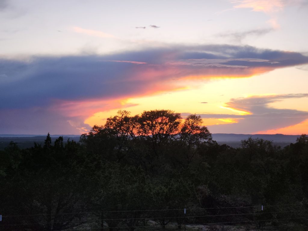 Sunset looking west from Polly's Peak, Bandera County, Texas, USA on 29 May 2023.